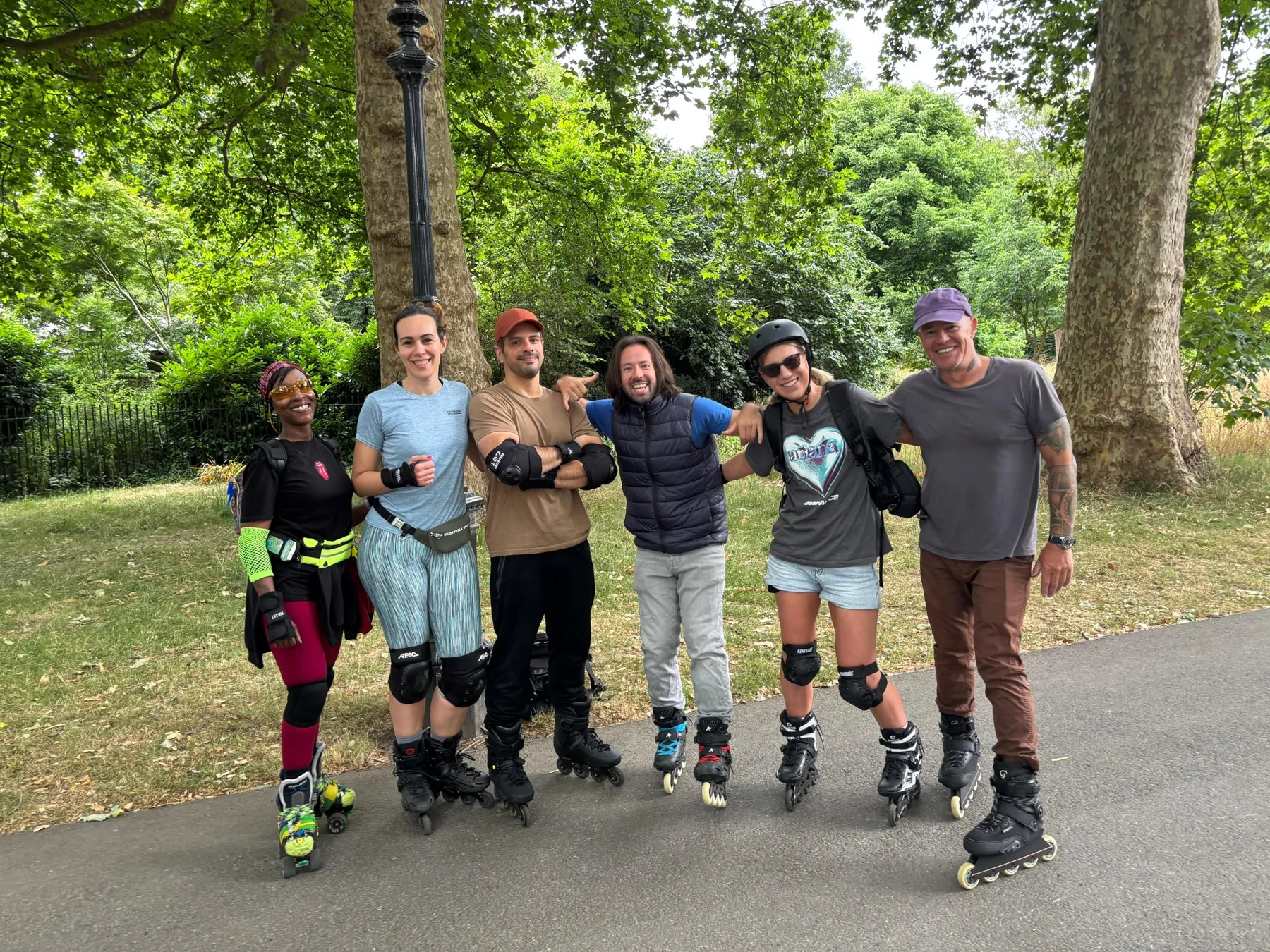 Adrian and a group of skaters smiling together in a park